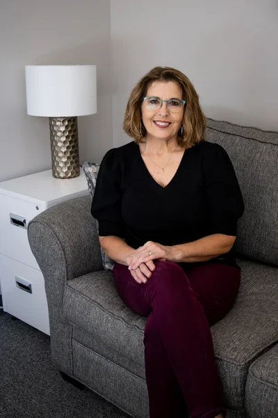Rachele Epp, LMHC seated on a couch
