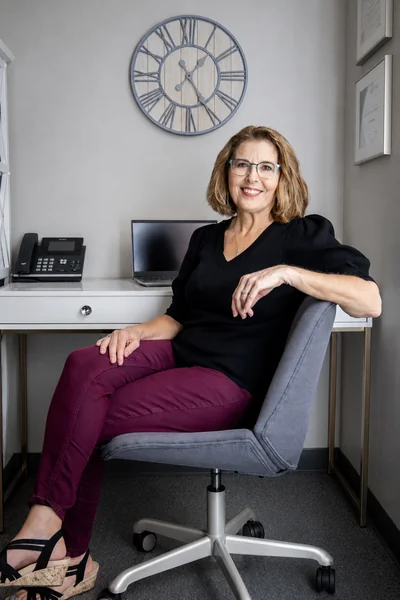 Rachele Epp, LMHC seated at her desk
