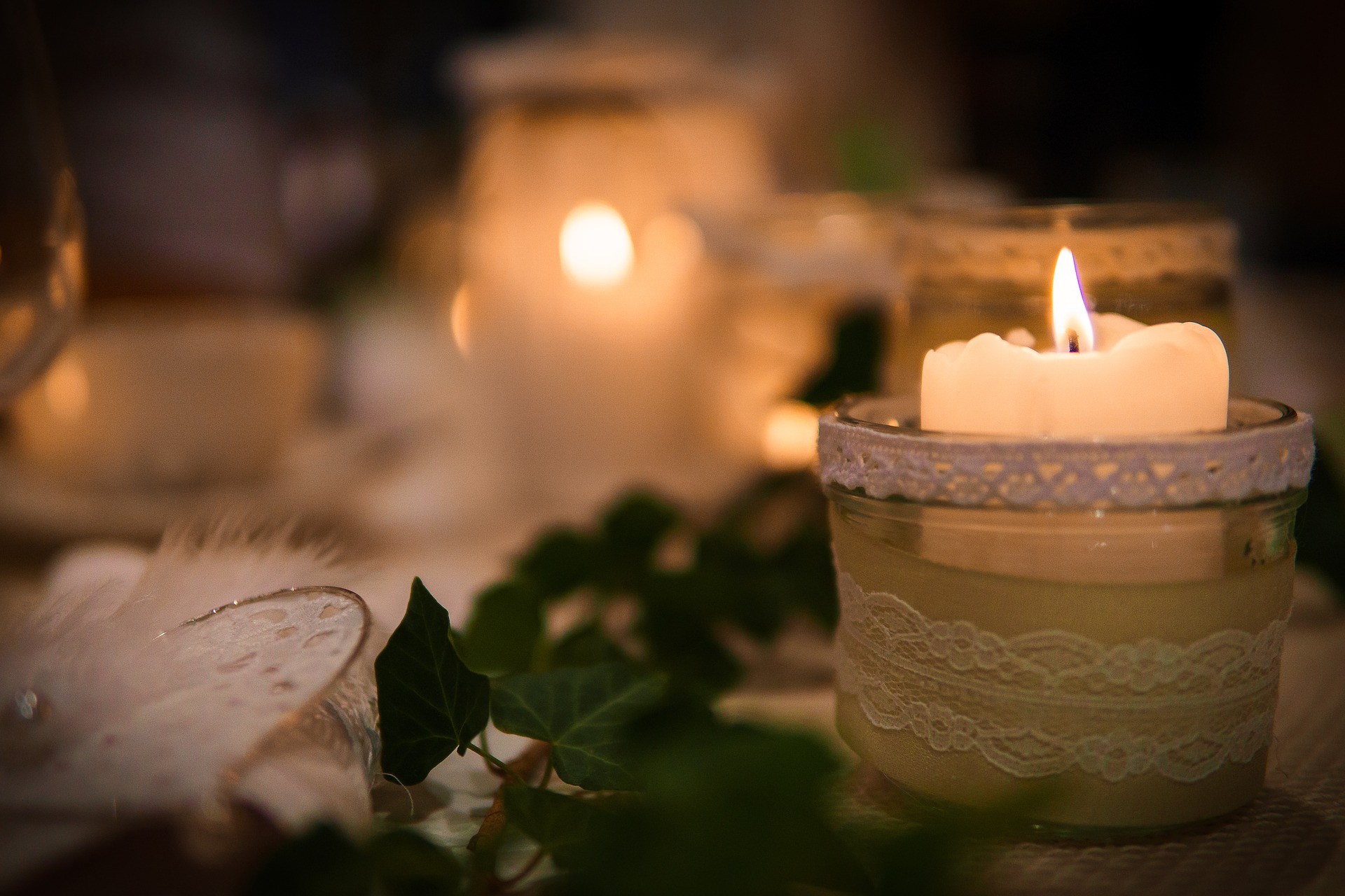 Anxiety, Finding Peace, White pillar candles in cups with lace and ivy greenery.